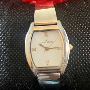 Beautiful silver women’s Anne Klein watch works perfectly. Red gift box/pillow.